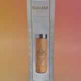 The Bhavana Bamboo Infuser Traveler Tumbler container on a pink and yellow background.