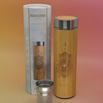 The Peace Bhavana Bamboo Infuser Traveler Tumbler on a pink and yellow background.