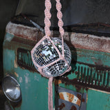 Someone holding the blush and mustard Color Dip Disco Ball Hanger - Macrame Plant Hanger in front of a vintage teal Volkswagen bus.