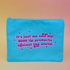 The Me & My Lip Products Against The World Canvas Zipper Pouch on a pink and yellow background.