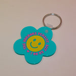 The Horrors Persist But So Do I Flower Shaped Vinyl Keychain on a light pink background.