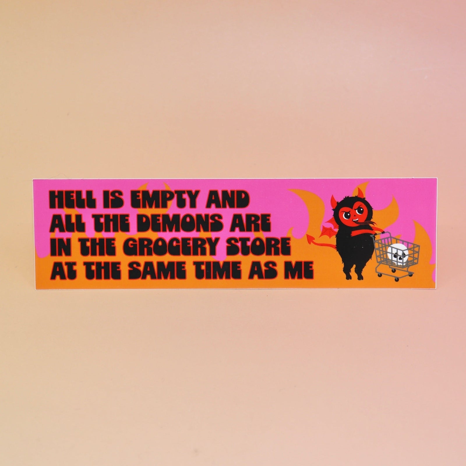 The Hell Is Empty Demons Are In The Grocery Store Vinyl Bumper Sticker on a light pink background.