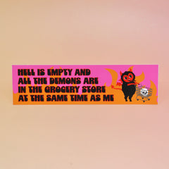 The Hell Is Empty Demons Are In The Grocery Store Vinyl Bumper Sticker on a light pink background.