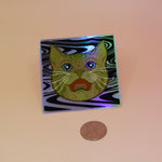 The Cozmik Love Cat 3" Holographic Vinyl Sticker next to a quarter on a light pink background.