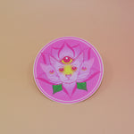 The Four Eared Lotus 3” Round Vinyl Sticker on a light pink background.