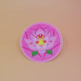 The Four Eared Lotus 3” Round Vinyl Sticker on a light pink background.