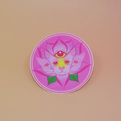 The Four Eared Lotus 3” Round Vinyl Sticker on a light pink background.