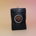 The Mystery Crystal Grab Bag - 5 Count on a pink and yellow background.
