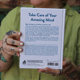 A woman holding the Self-Care for People with ADHD Hardcover Book.