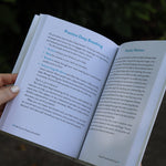 A woman holding the Self-Care for People with ADHD Hardcover Book open to show off its pages.