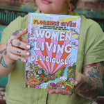 A woman holding the Women Living Deliciously Hardcover Book.