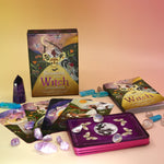 The contents of the Seasons of the Witch - Litha Oracle Card Deck with crystals around them.
