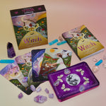 The contents of the Seasons of the Witch - Litha Oracle Card Deck with crystals around them.