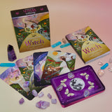 The contents of the Seasons of the Witch - Litha Oracle Card Deck with crystals around them.