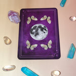 The back of a card from the Witch - Litha Oracle Card Deck surrounded by crystals.
