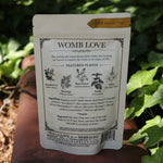 The back of  the Womb Tea - Nourish + Empower Tonic Tea red surface next to ivy.