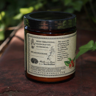 The Ashwagandha Nature's Chill Pill 4 oz Powder on a rusty red surface surrounded by ivy.
