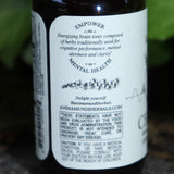 The side of the Cerebrum - Nootropic + Cognitive Support Tonic on a concrete surface in front of ivy.