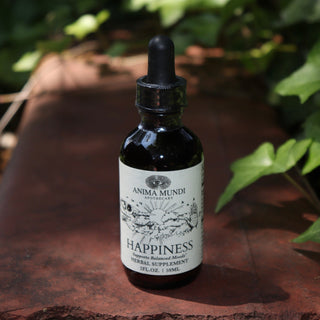The Happiness Tonic - 2 fl. oz. Adaptogenic Spirit Tonic on a red rusty surface surrounded by green ivy.