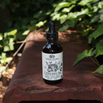 The Cerebrum - Nootropic + Cognitive Support Tonic on a rusty red surface surrounded by ivy.