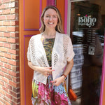 A woman wearing the beige Lace Open Front Cardigan with Batwing Sleeves with tie-dye bottoms and top.