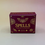 The Spells A Little Deck of Enchantment Spell Deck on a pink and yellow background.
