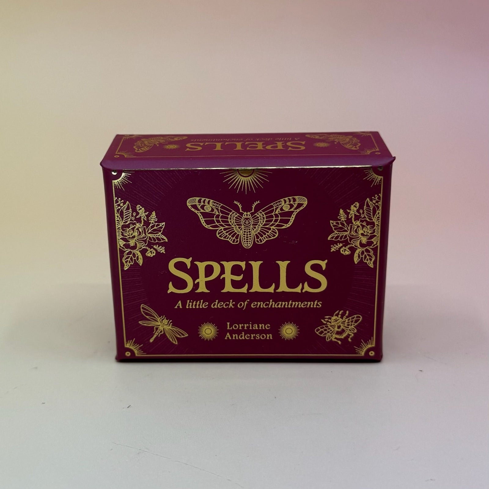 The Spells A Little Deck of Enchantment Spell Deck on a pink and yellow background.