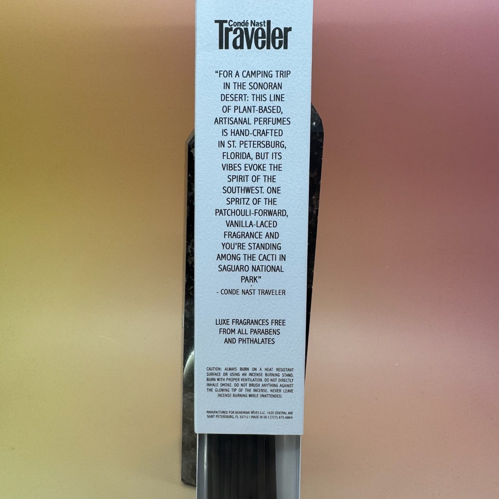 The Desert Fleur Incense by Bohemian Rêves on a pink and yellow background, showing off the back.