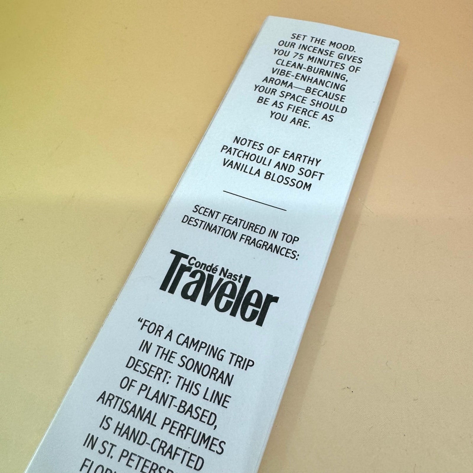 The Desert Fleur Incense by Bohemian Rêves on a pink and yellow background, showing off the back.