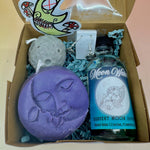 The Moon Lovers Gift Box open on a pink and yellow background.