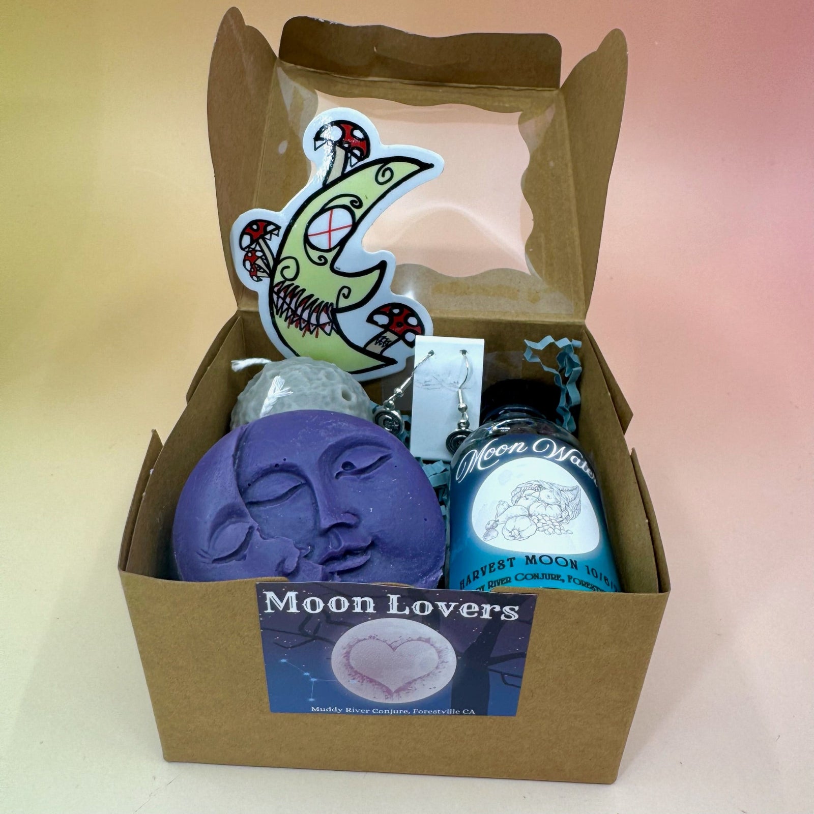 The Moon Lovers Gift Box open on a pink and yellow background.
