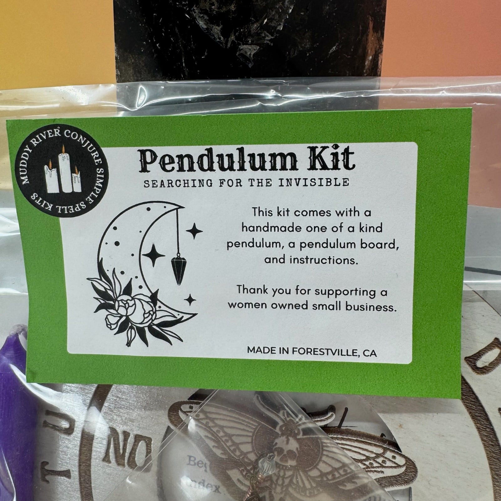 The Pendulum Kit on a pink and yellow background.