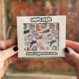 Someone holding the Cozy Cat Hardcover Cigarette Case in front of a wooden background.