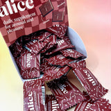 The Happy Ending Single Chocolates - Mushroom Chocolate for Arousal on a peach-colored background.