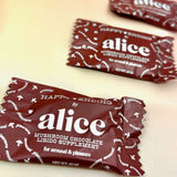 The Happy Ending Single Chocolates - Mushroom Chocolate for Arousal on a peach-colored background.