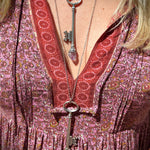Someone wearing the Raw Amethyst and clear quartz Crystal Necklaces Vintage Skeleton Key in Silver.