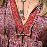 Someone wearing the Raw Amethyst and clear quartz Crystal Necklaces Vintage Skeleton Key in Silver.