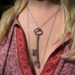 Someone wearing the Raw Amethyst Crystal Necklace Vintage Skeleton Key in Silver.