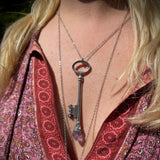 Someone wearing the Raw Amethyst Crystal Necklace Vintage Skeleton Key in Silver.