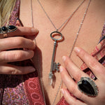 Someone wearing the Raw Clear Quartz Crystal Vintage Key Necklace in Silver.