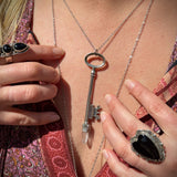 Someone wearing the Raw Clear Quartz Crystal Vintage Key Necklace in Silver.