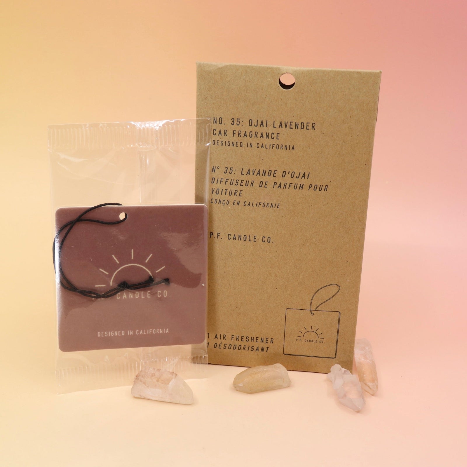 The P.F. Candle Co. Ojai Lavender - Car Fragrance on a pink and yellow background.