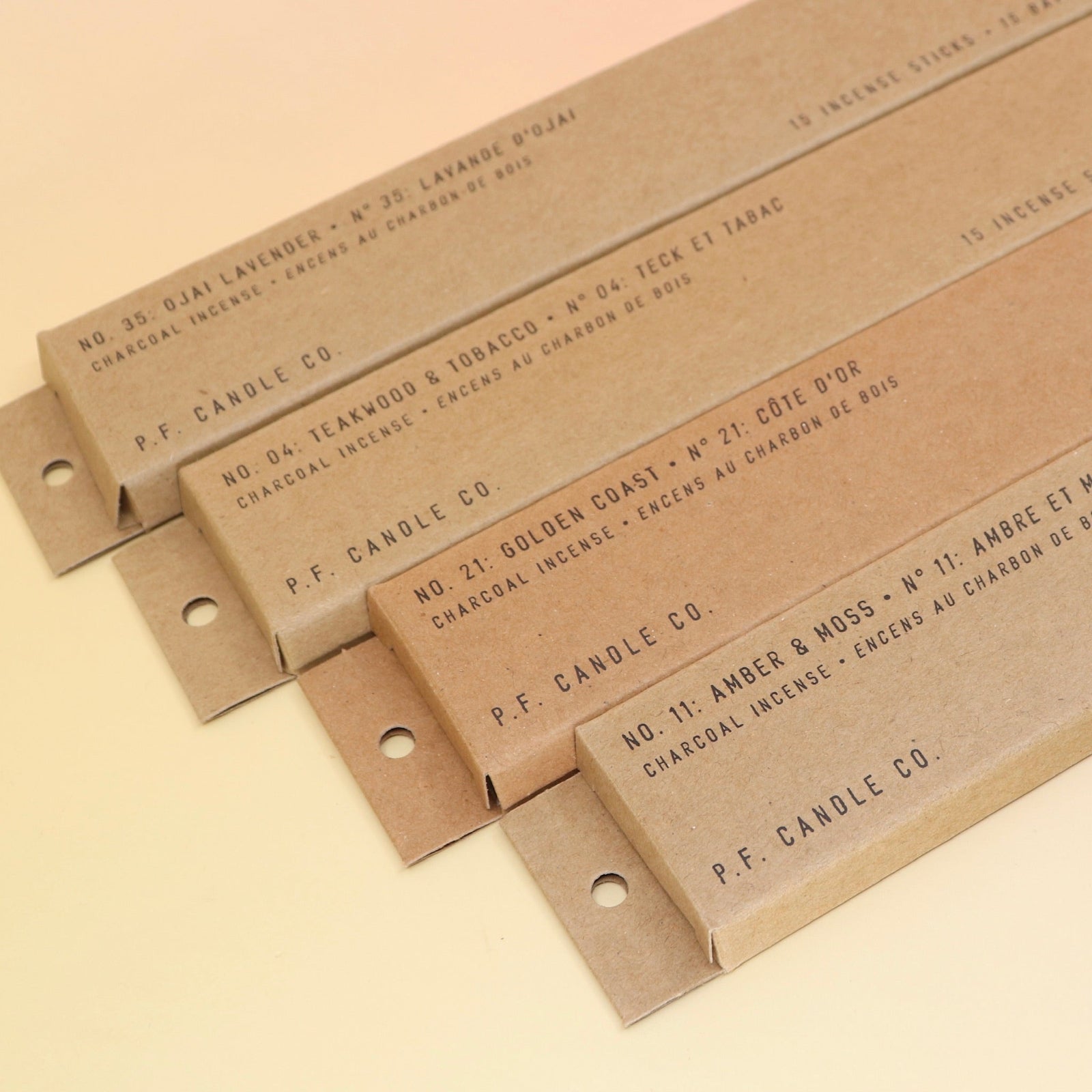 All four P.F. Candle Co. incense (Amber & Moss, golden Coast, Teakwood & Tobacco, and Ojai Lavender) on a pink and yellow background.