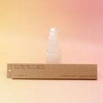 The P.F. Candle Co. Golden Coast Incense in front of a selenite tower on a pink and yellow background.