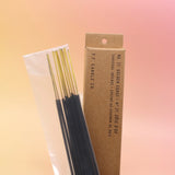 The P.F. Candle Co. Golden Coast Incense on a pink and yellow background.