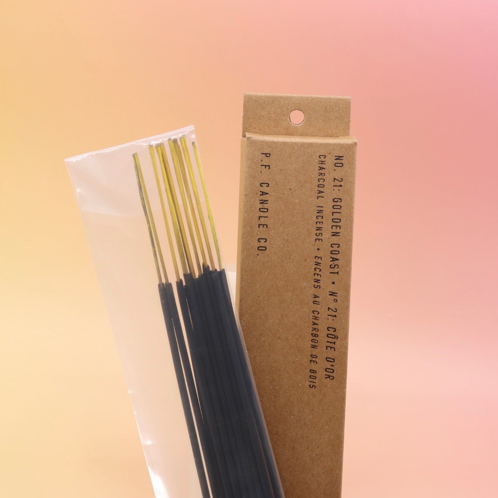 The P.F. Candle Co. Golden Coast Incense on a pink and yellow background.