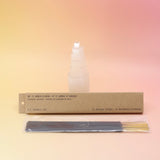 The Amber & Moss Incense - Pack of 15 from P.F. Candle Co. in front of a selenite tower on a pink and yellow background.