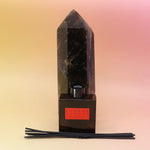 The Blonde Hinoki – HI-FI Reed Diffuser bottle in front of a crystal tower on a pink and yellow background.