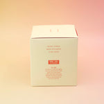 The side of the Blonde Hinoki - HI-FI Soy Wax Candle box on a pink and yellow background.