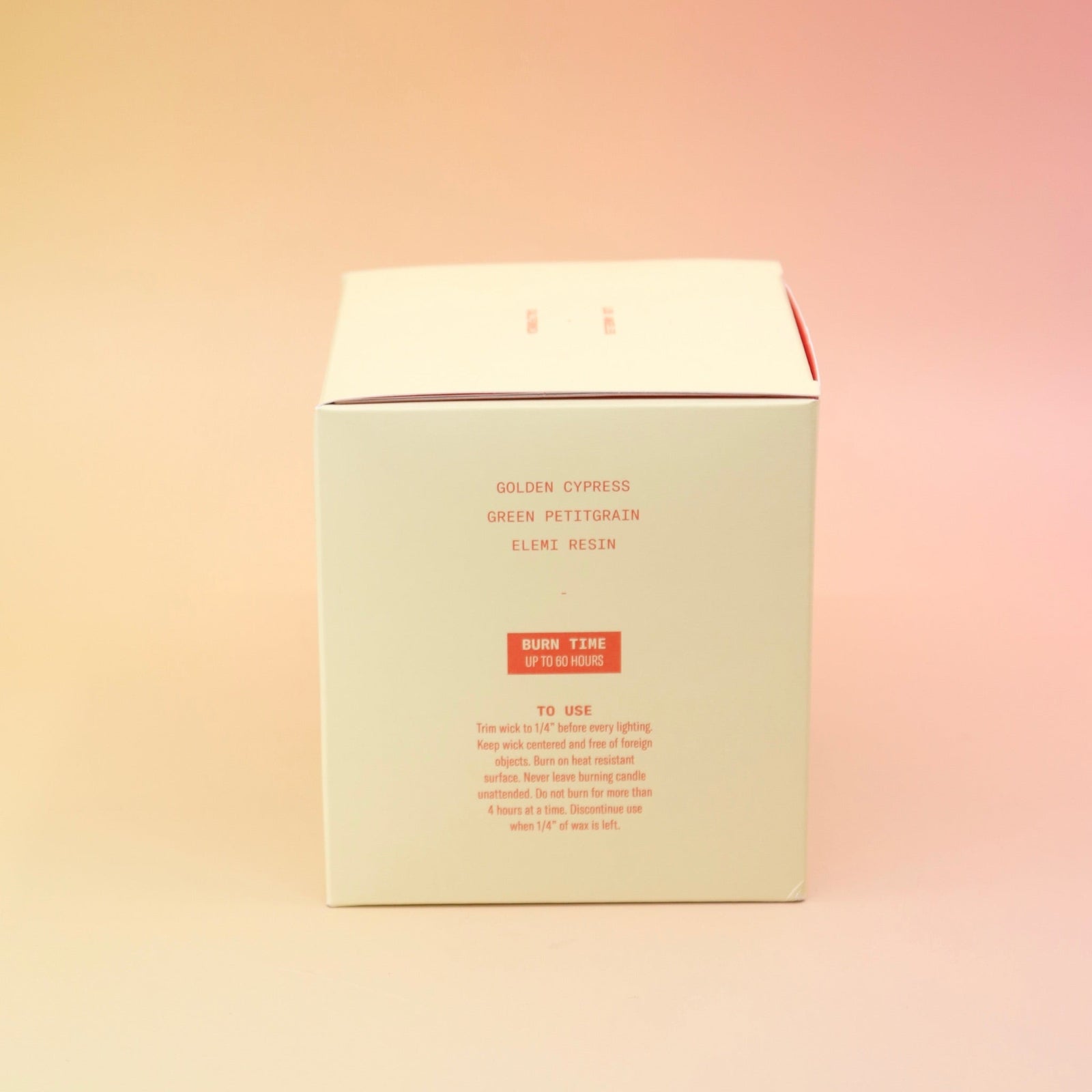 The side of the Blonde Hinoki - HI-FI Soy Wax Candle box on a pink and yellow background.